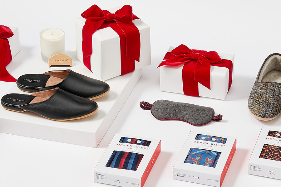 slippers, boxers and boxes with red bows on a white table
