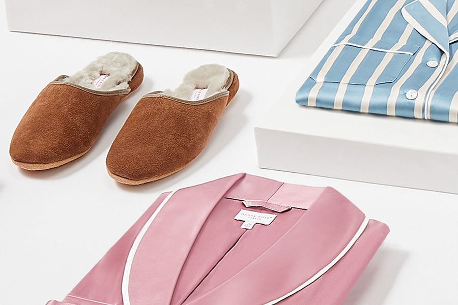 Brown suede slippers on a white table