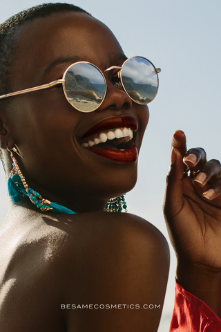 Black woman smiling wearing red lipstick