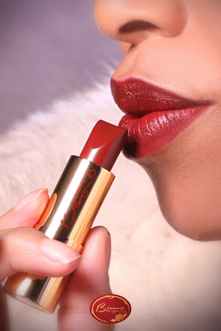 Woman Applying Bésame's Red Velvet Lipstick