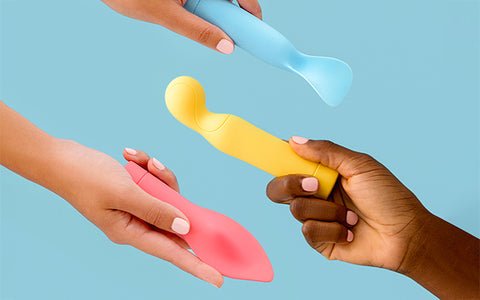 hands holding colorful vibrators