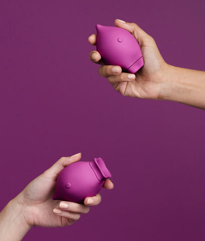 a purple clit suction toy on a purple background