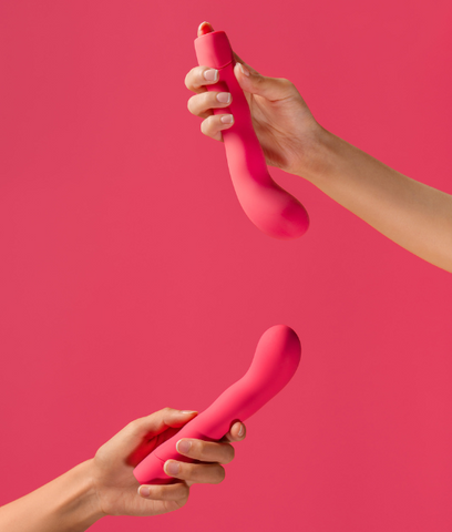 two bright red vaginal vibrators on a red background