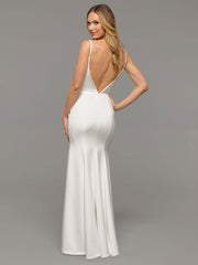 Image of blonde woman modeling the back of a backless wedding dress.
