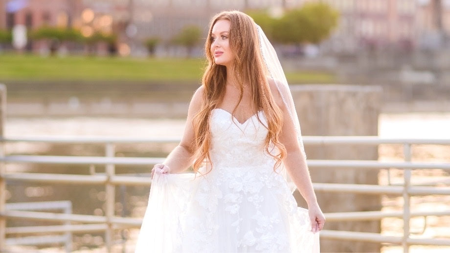 Image of bride wearing wedding dress outside.