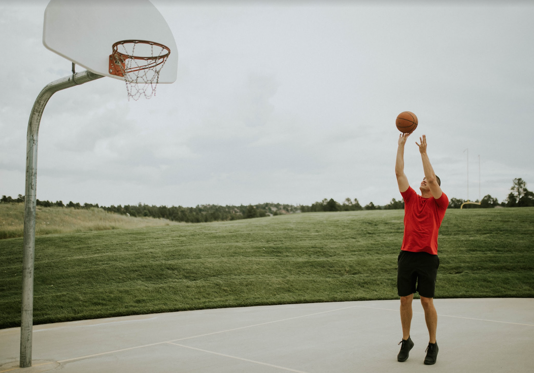 Tall Guy Wearing Tall Athletic Shirt Playing Basketball