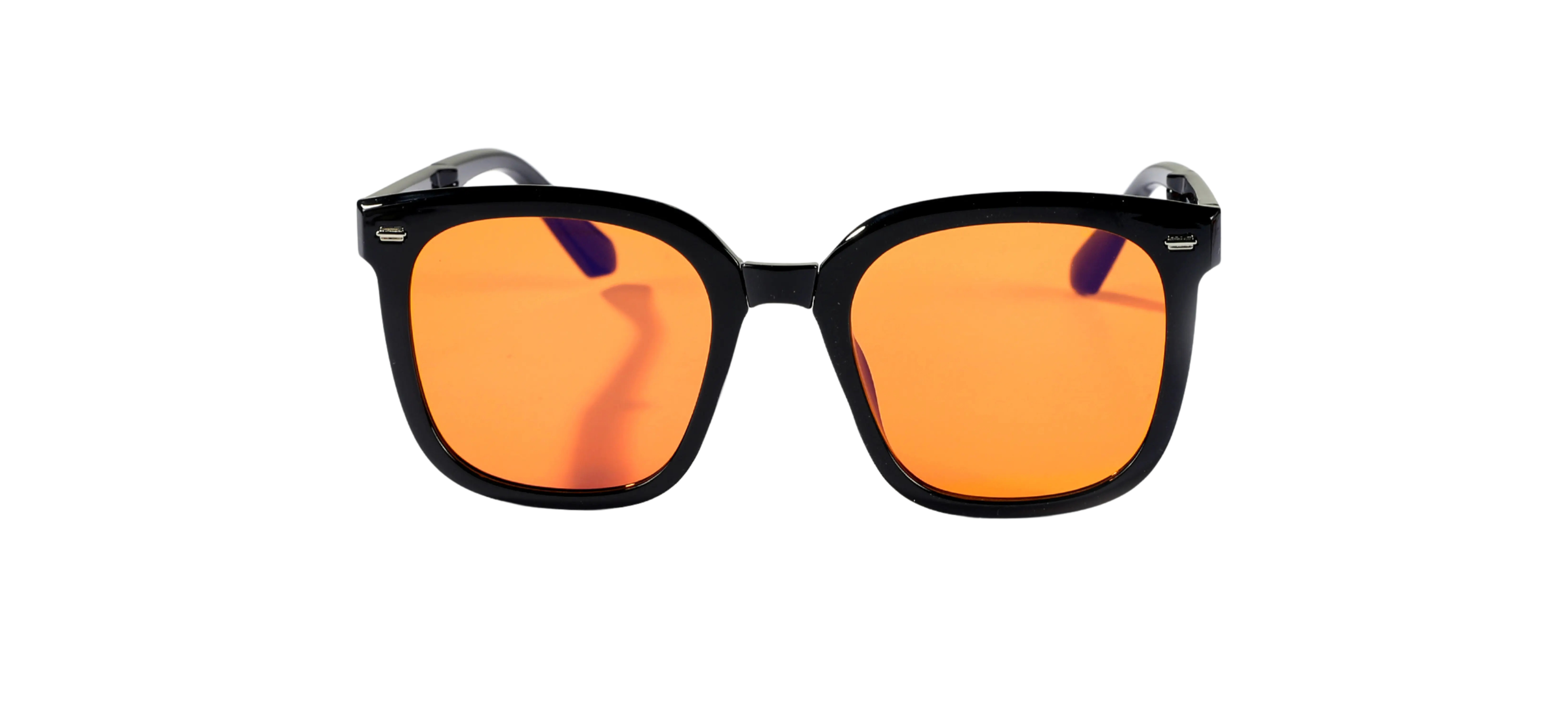 Black sunglasses with orange tinted lenses against a black background.