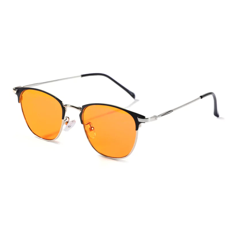 A pair of orange-lensed, black-framed sunglasses against a white background.