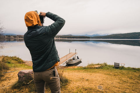 Howler Outerwear Lifestyle Man Taking Picture Of Lake Image
