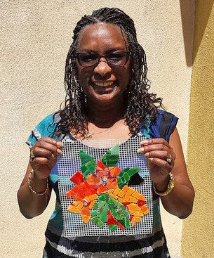 Community member working on Broadway's Blooming mosaic wall.