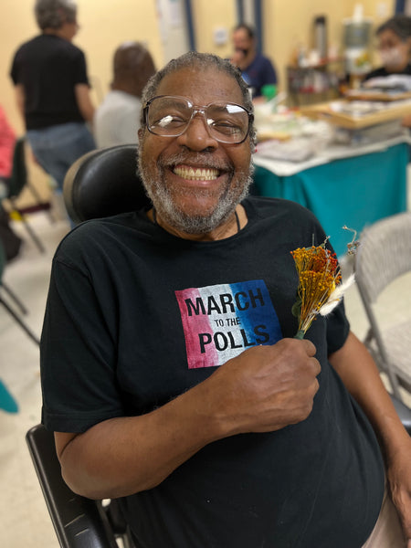 John M holding dried flowers