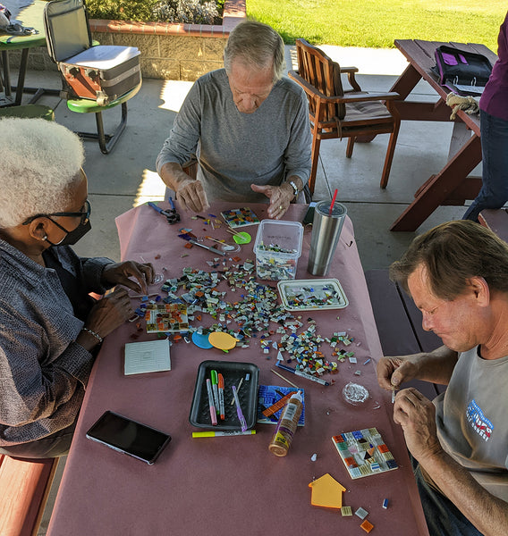 Instructor Bea working with Veterans on mosaics