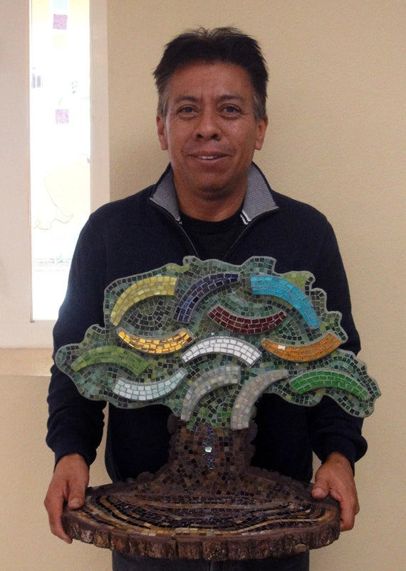 Jose M with a tree mosaic he created