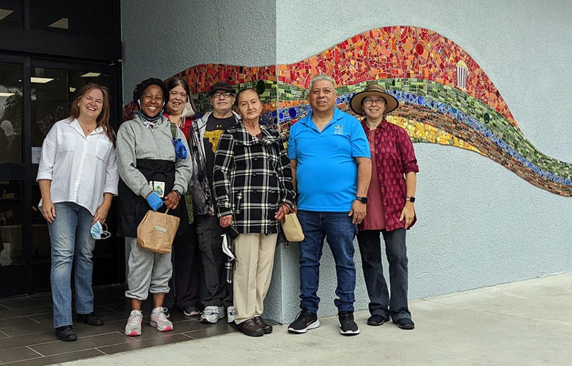 Piece by Piece artists standing in front of the completed mosaic