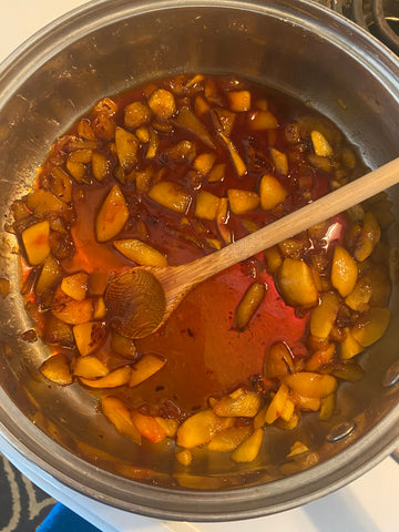 peach cobbler filling in a sauce pan