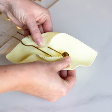 Using your hands and a sunshine polishing cloth to polish your jewelry after you wear it.