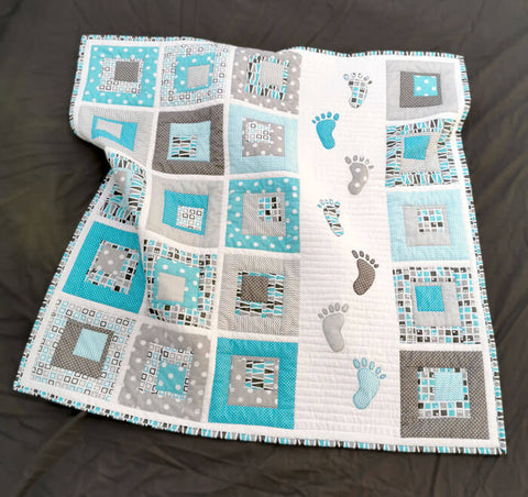 Blue baby quilt with baby footsteps