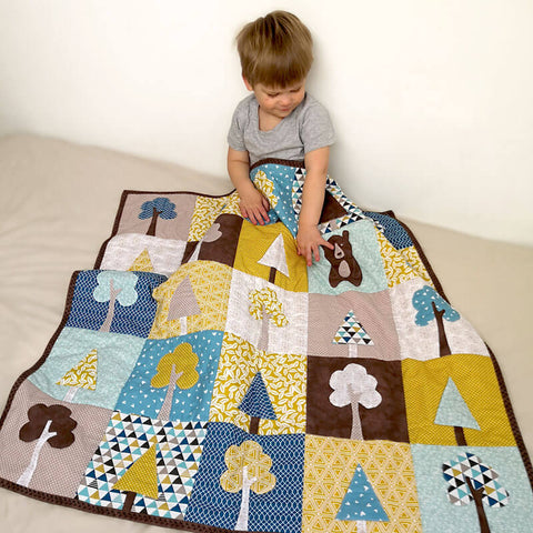 A child enjoying tree quilt "Our Forest Winter"