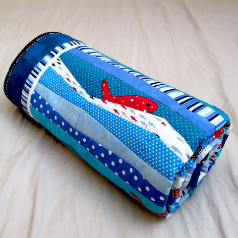 Red fish appliqued on blue nautical explorer quilt