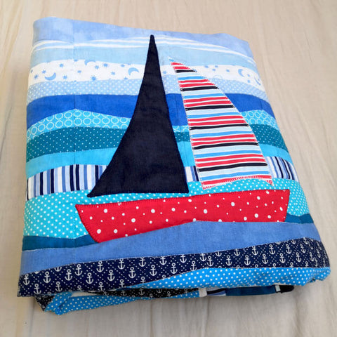 Ship applique on blue ocean quilt