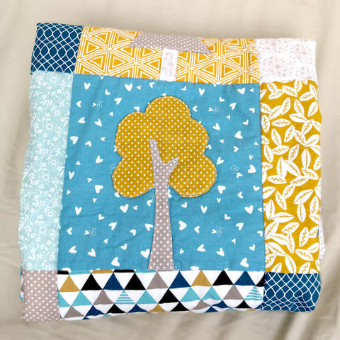 Yellow tree applique on "Our Forest Winter" quilt