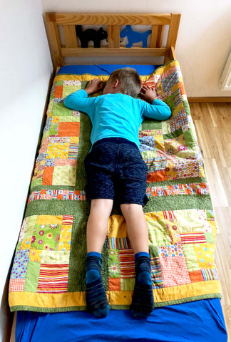 Kid on quilt. Kids love their baby quilts