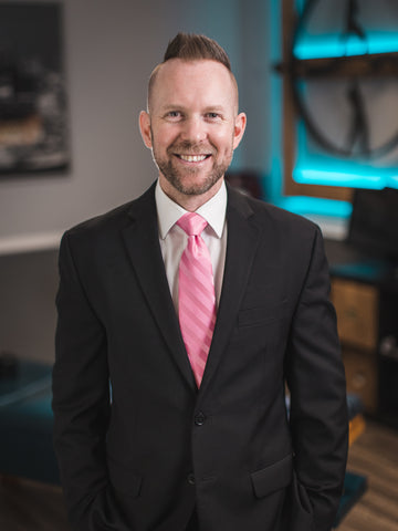 Picture of Dr. Jeremy Landry, D.C. in a black suit with a pink tie