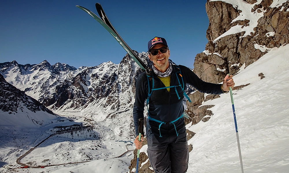 Davenport hiking with skis on his backpack