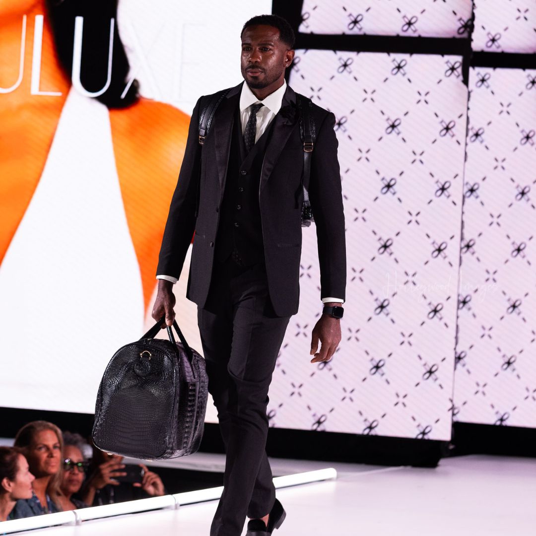 Model on runway with duffle bag at New York Fashion Week