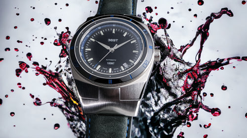 Blue bezel Watch with splash color in the background 