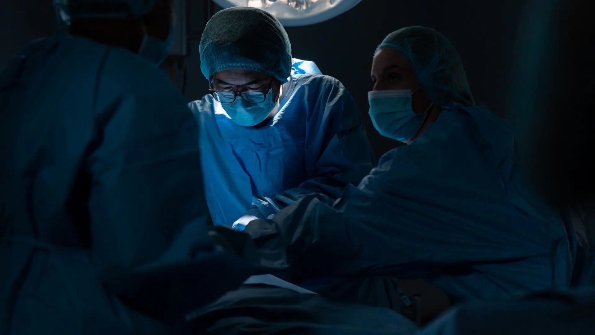 surgeons at an operation room performing surgery