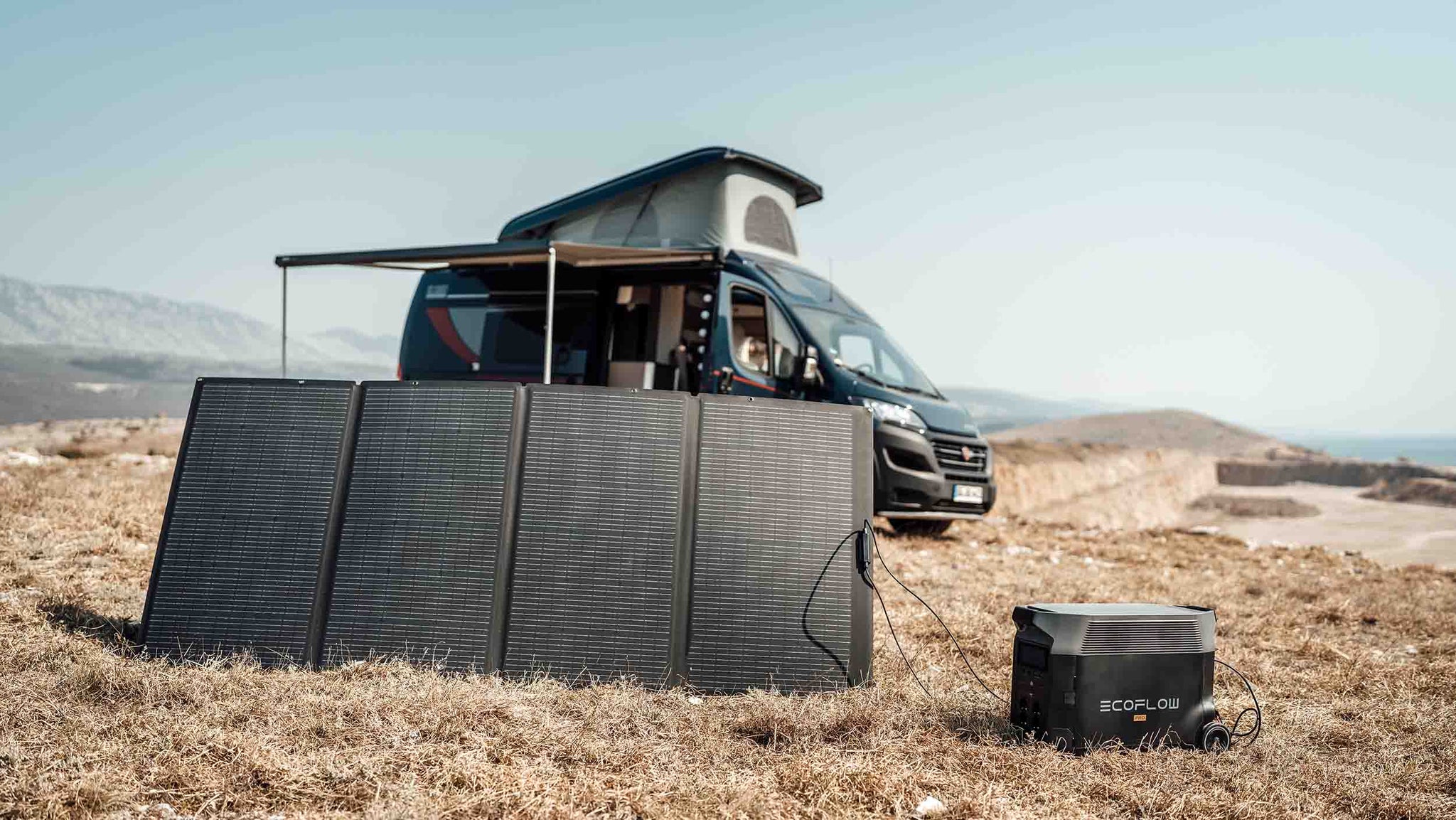 EcoFlow DELTA Pro being charged by a solar panel in front of an RV