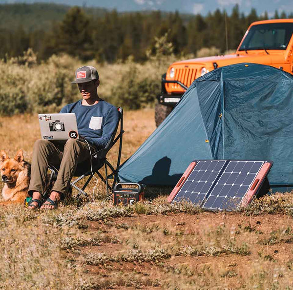 Jackery Explorer 240 Portable Power Station Being Charged By A SolarSaga Panel At A Campsite