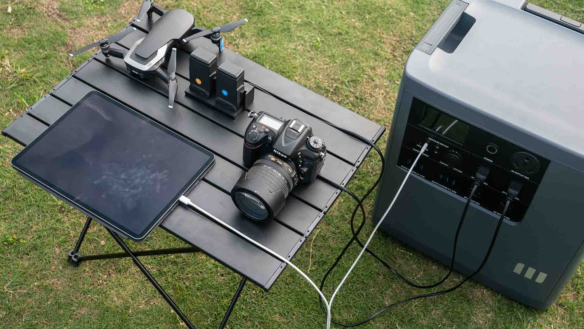 Mango Power E Charging a Tablet, Camera, and a Drone