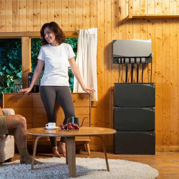 Woman Standing With A 4kWh Power Kit In A Tiny Home