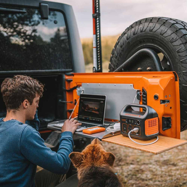 Working on a laptop in the back of a Jeep with the Jackery Explorer 290