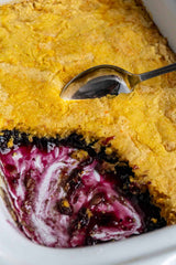 A serving dish with Crock Pot Blueberry Cobbler