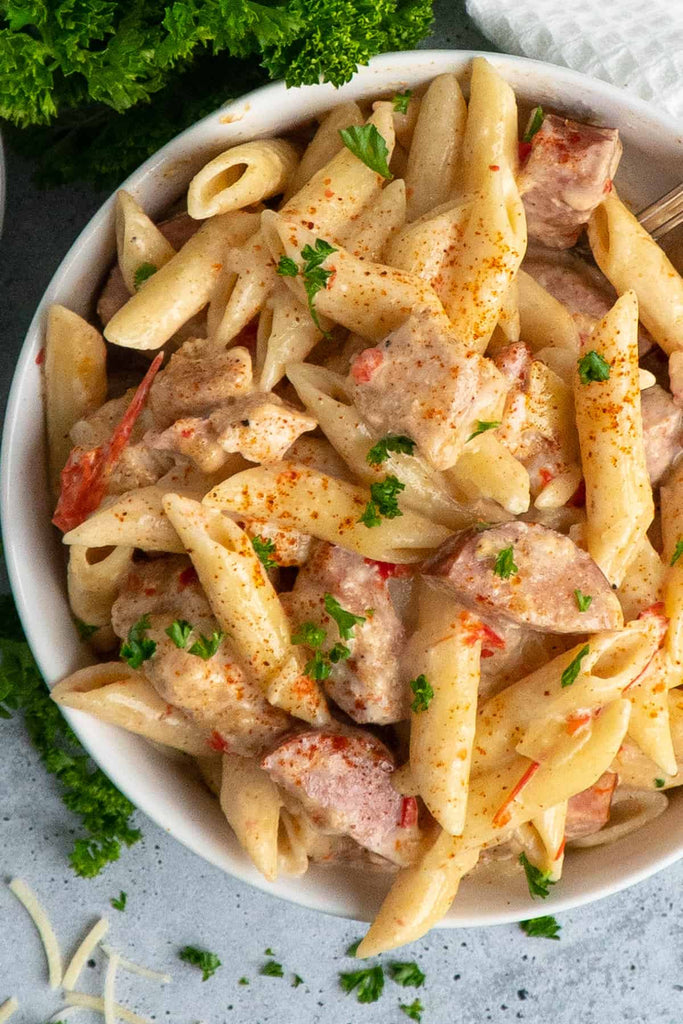 Crock Pot Cajun Chicken Pasta in a serving bowl setting on a table