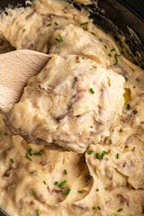 Garlic Mashed Potatoes in a bowl with a wooden spoon