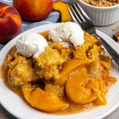 Peach Cobbler with Cake Mix on a plate with ice cream