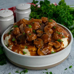 A bowl of mashed potatoes and Salisbur Steak Meatballs