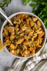 Cornbread stuffing in a bowl with a spoon