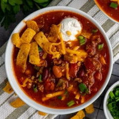 Chili cooked in a Crock Pot with sour cream