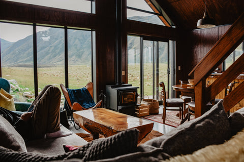 a mountain cabin living room with couch chairs and tables