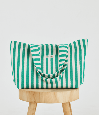 Green Stripe "Nadia" Herringbone Woven Linen Tote Bag placed on a table
