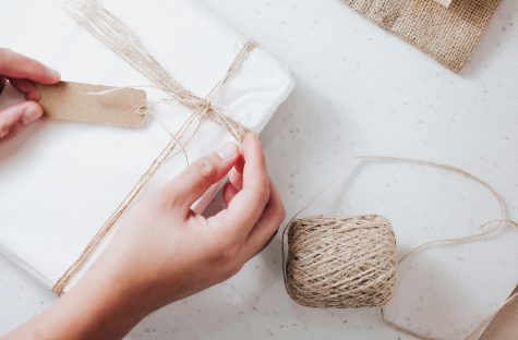 a person wrapping a gift box for gifting towels