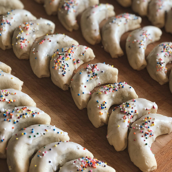 Beautiful Cuccidati cookies with lemon icing and sprinkles