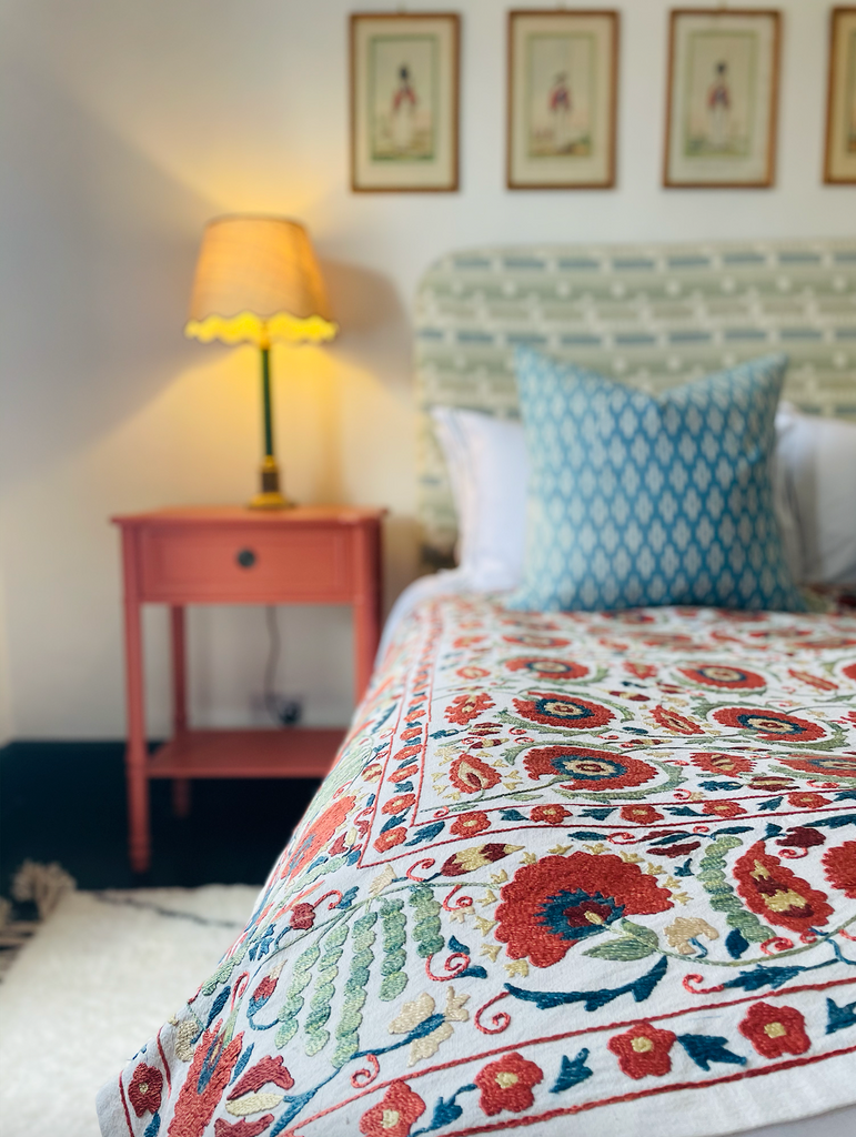 an example of a vintage cotton suzani textile Holly has sourced from Uzbekistan and displays over her bed