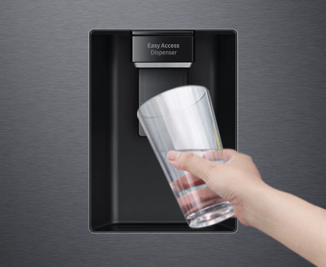 A person touches the dispenser button with the cup to get the chilled, refreshing water from the Water Dispenser.