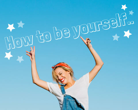 A blonde woman in front of a clear blue sky has a smiler on her face and her hands in the air pointing to a title saying 'How to be yourself..'